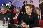 French President Nicolas Sarkozy, right, and Paraguay's President Fernando Lugo, left, attend the plenary session of the EU Latin America summit in Madrid, on Tuesday, May 18, 2010. In the background right is French Foreign Minister Bernard Kouchner. Spain says the European Union and the South American trade bloc known as Mercosur has agreed to resurrect stalled talks on reaching an ambitious free trade agreement.