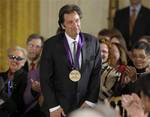 Actor Al Pacino shows off his 2011 National Medal of Arts during a ceremony in the East Room of the White House in Washington, Monday, Feb. 13, 2012. (AP Photo/Susan Walsh)