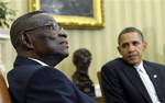 President Barack Obama listens as President John Evans Atta Mills of Ghana, left, speaks in the Oval Office of the White House in Washington, Thursday, March 8, 2012. (AP Photo/Susan Walsh)