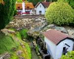 Watermill with Barley Corn Pub in background at Bekonscot model village, Beacons field, Buckingham shire. The site is approximately two acres of which just over half is a miniature 1:12 landscape.