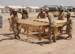 Seabees assigned to Naval Mobile Construction Battalion (NMCB) 5 move a work platform during the relocation of the Barley Company Pre-Fabrication Yard at Camp Natasha.