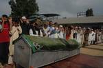 Kashmiri Muslims offer prayers to ruling party National Conference Block President Abdul Rehman Ganaie during his funeral in Srinagar on June 15,2012. Suspected Muslim rebels gunned down Ganaie in the latest string of alleged political killings in Kashmir. Ganaie was shot at close range by suspected rebels as he was leaving his home to offer Friday prayers at a local mosque,police said.