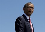 President Barack Obama looks out over the crowd as first Lady Michelle Obama, not seen, speaks to troops, veterans and military families at theThird Infantry Division Headquarters, Friday, April 27, 2012, Fort Stewart, Ga.