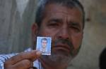 The father of Palestinian gunman Ahmed Nassir holds his picture at his family's house in Khan Younis in the southern Gaza Strip. -- Relatives mourn for the death of a Palestinian militant, who was killed during an exchange of fire near the Gaza border, sources on both sides said. An Israeli soldier was also killed. 01 June 2012. Photo By Ahmed Deeb/wn