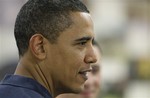 President Barack Obama pauses as he and first lady Michelle Obama greet marines during Christmas dinner at Anderson Hall on Marine Corps Base Hawaii in Kailua, Hawaii Friday, Dec. 25, 2009. The Obamas are in Hawaii for the holidays.