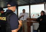 CAPE MAY, N.J. - Petty Officer 2nd Class Bill Stubbe, a member of Coast Guard Vessel Boarding and Security Team in Philadelphia, speaks with Capt. David Macomber, captain of the Cape May-Lewes Ferry, alongside other federal law enforcement agents aboard the ferry Saturday, August 15, 2009. The Coast Guard was one agency involved in a multi-agency maritime law enforcement operation which included state and federal law enforcement agents conducting operations at the Cape May-Lewes Ferry Terminal i