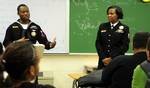 Boatswains Mate 2nd class Simone T. McClain, right, and Boatswains Mate 2nd class Antwan Miller, left, speak with students at Kempsville High School in Virginia Beach, Va., about bullying.