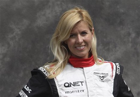 FILE - In this Thursday, March 15, 2012 file photo, Marussia test driver Maria de Villota of Spain poses for a photo ahead of the Australian Formula One Grand Prix at Albert Park in Melbourne, Australia.