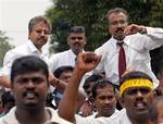 From left in background, Hindu Rights Action Force chairman P. Waytha Moorthy, V. Ganapathy Rao and P. Uthayakumar are lifted by their supporters after being discharged from a court in Klang, outside Kuala Lumpur, Malaysia, Monday, Nov. 26, 2007. The three ethnic Indian activists charged with sedition walked free Monday on a technicality, a day after they organized a rally of 10,000 people to protest Malaysian government policies that they say discriminate against minority Indians.