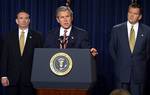 President George W. Bush discusses his smallpox vaccination program during a press conference as Secretary of Health & Human Services Tommy Thompson, left, and Director of the Office of Homeland Security Tom Ridge in the Dwight D. Eisenhower Executive Of