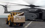 oatswain's Mate 3rd Class Ronnie Guerra operates a forklift to unload supplies from a MH-53E helicopter from Helicopter Mine Countermeasures Squadron (HM) 15 aboard the amphibious dock landing ship USS Whidbey Island.