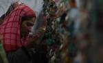 Kashmiri Muslim woman pray outside the shrine of Sufi saint Hazrat Sheikh Hamza Makhdoom, commonly known as Sultan-Ul-Arifeen, during the saint's Urs, or yearly commemoration, in Srinagar, the summer capital of Kashmir, 29 January 2011. Thousands of Kashmiri Muslims who believe in Sufism thronged the shrine to offer prayers.