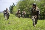 Seabees assigned to Naval Mobile Construction Battalion 74 execute a reconnaissance patrol during a field training exercise, March 20, at Camp Shelby, Miss. The exercise provides a robust training environment where Seabee forces plan and execute multiple mission essential tasks prior to deployment. Petty Officer 2nd Class Ernesto Hernandez Fonte