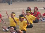 Primary school children on the school ground performing some exercises in the school function - education - students - India