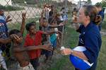 US Navy 070814-N-4954I-068 Mass Communication Specialist 2nd Class Jennifer Hudson blows soap bubbles for local children while waiting for a helicopter flight back to the amphibious assault ship USS Peleliu (LHA 5)