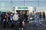 Special police, left, and security officers, right, seen at an entrance to Domodedovo airport near Moscow on Tuesday, Jan. 25, 2011. Security was tightened in Moscow on Tuesday, after a suicide bomber set off an explosion that ripped through Moscow's busiest airport on Monday.