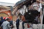 People walk through debris after an explosion ripped through a cafe popular among foreign tourists in the Moroccan city of Marrakech, Thursday, April, 28, 2011 which killed and wounded people in what the government called a suspected criminal act. If confirmed as terrorism, the blast in the iconic Djemma el-Fna square would be Morocco's deadliest bombing in eight years.