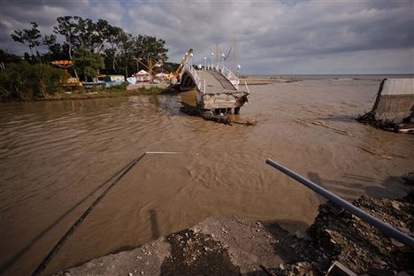 A bridge is destroyed by flooding in the Black Sea resort of Gelendzhik, southern Russia, Saturday, July 7, 2012.