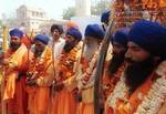 Sikh holy men line up in New Delhi during a procession from the state of Patna to the temple of Anandpur Sahib Tuesday April 6, 1999. Sikhism was meant to be a pacifist religion, but turned to militarism. For centuries, Sikhs were unified, but now their