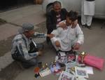 Kashmiri activists including the father of of Wamiq Farooq (C) hold photographs of him, on the anniversary of his death, as they take part in a protest rally in Srinagar on June 11 ,2012,