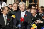 The founder of WikiLeaks Julian Assange, center, gives a statement to the media after his extradition hearing at the High Court in London, Wednesday, Nov. 2, 2011. Assange on Wednesday lost his appeal against extradition to Sweden to answer sex crime allegations, but may now take his protracted fight to Britain's highest court. (AP Photo/Kirsty Wigglesworth)