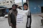 Palestinians receive their monthly food aid at a UN distribution center in the Shati refugee camp,January 17, 2012, in Gaza City. The UN Agency for Palestinian Refugees (UNRWA) in Gaza launched an appeal for emergency funds to the Palestinian territories of $ 300 million (235 million), The Deputy Chief Commissioner Margo Ellis at the third anniversary of the end of the devastating Israeli operation 