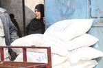 Palestinians receive their monthly food aid at a UN distribution center in the Shati refugee camp,January 17, 2012, in Gaza City. The UN Agency for Palestinian Refugees (UNRWA) in Gaza launched an appeal for emergency funds to the Palestinian territories of $ 300 million (235 million), The Deputy Chief Commissioner Margo Ellis at the third anniversary of the end of the devastating Israeli operation 