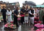 Mufti Mohammad Sayeed (c), former chief minister of Jammu and Kashmir, decorating graves at Martyr's Graveyard to mark Martyr's Day cermony at the Mazar-e-Shohda (Martyr's graveyard) in Srinagar , the summer capital of Indian Kashmir, 13 July 2012. Authorities Friday clamped severe restrictions in Srinagar city, the region's summer capital to thwart the separatist march on the eve of Martyrs' day in Indian Kashmir.The restrictions were enforced by contingents of Indian police and paramilitary tr