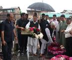 Mufti Mohammad Sayeed (c), former chief minister of Jammu and Kashmir, decorating graves at Martyr's Graveyard to mark Martyr's Day cermony at the Mazar-e-Shohda (Martyr's graveyard) in Srinagar , the summer capital of Indian Kashmir, 13 July 2012. Authorities Friday clamped severe restrictions in Srinagar city, the region's summer capital to thwart the separatist march on the eve of Martyrs' day in Indian Kashmir.The restrictions were enforced by contingents of Indian police and paramilitary tr