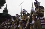 Indian policemen in ceremonial attire perform during a ceremony marking Martyrs' Day at the Mazar-e-Shohda (Martyr's graveyard) in Srinagar , the summer capital of Indian Kashmir, 13 July 2012. Authorities Friday clamped severe restrictions in Srinagar city, the region's summer capital to thwart the separatist march on the eve of Martyrs' day in Indian Kashmir.The restrictions were enforced by contingents of Indian police and paramilitary troopers of India's Central Reserve Police Force (CRPF) d