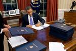 President Barack Obama signs legislation in the Oval Office, Dec. 22, 2010. (Official White House Photo by Pete Souza) This official White House photograph is being made available only for publication by news organizations and/or for personal use printing by the subject(s) of the photograph. The photograph may not be manipulated in any way and may not be used in commercial or political materials, advertisements, emails, products, promotions that in any way suggests approval or endorsement of the