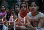 A group of Kashmiri students hold candles as they stage a symbolic protest against corruption on the banks of Dal Lake in Srinagar, the summer capital of Indian Kashmir, 15 May 2012. Protesters comprised of students from medicine, journalism, law and social science. Corruption in India has been at the forefront of the debate as the parliament in last session tried to pass an anti-corruption bill, but failed to pass it as the legislators couldn't develop a consensus over the issue.