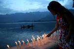 A group of Kashmiri students hold candles as they stage a symbolic protest against corruption on the banks of Dal Lake in Srinagar, the summer capital of Indian Kashmir, 15 May 2012. Protesters comprised of students from medicine, journalism, law and social science. Corruption in India has been at the forefront of the debate as the parliament in last session tried to pass an anti-corruption bill, but failed to pass it as the legislators couldn't develop a consensus over the issue.