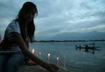 A group of Kashmiri students hold candles as they stage a symbolic protest against corruption on the banks of Dal Lake in Srinagar, the summer capital of Indian Kashmir, 15 May 2012. Protesters comprised of students from medicine, journalism, law and social science. Corruption in India has been at the forefront of the debate as the parliament in last session tried to pass an anti-corruption bill, but failed to pass it as the legislators couldn't develop a consensus over the issue.