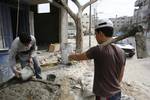 Palestinian workers working in Gaza City. -- Central of Statistics said that the rate of unemployment in the Palestinian territories, in 15 years individuals involved in the labor force was over 21%. About 222 thousand are unemployed, of whom 19% are males and 28% are females.. Photo By Ahmed DEEB/WN