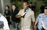 Ex-Chelsea star Didier Drogba waves to his fans upon his arrival at Pudong International Airport Saturday July 14, 2012 in Shanghai, China. Drogba signed with Shanghai Shenhua on a two-year contract.