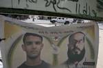 The family of Palestinian prisoner Mahmud Al-Sarsak sit in front of his images at their home, as they prepare for his release from an Israeli jail, on July 9, 2012. Sarsak, who should be released on July 10 following weeks of being on hunger strike, is a football player from the Gaza Strip and was detained by Israeli troops while traveling to play with the Palestinian team in the Israeli occupied Palestinian West Bank.Photo by Ahmed Deeb/wn