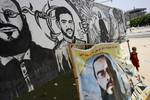 The family of Palestinian prisoner Mahmud Al-Sarsak sit in front of his images at their home, as they prepare for his release from an Israeli jail, on July 9, 2012. Sarsak, who should be released on July 10 following weeks of being on hunger strike, is a football player from the Gaza Strip and was detained by Israeli troops while traveling to play with the Palestinian team in the Israeli occupied Palestinian West Bank.Photo by Ahmed Deeb/wn