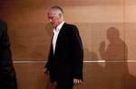 New coach of France's national football team, Didier Deschamps, center, is seen leaving a press conference with the silhouette of the President of the French soccer Federation (FFF) Noel Le Graet, right, at the end of a press conference, at the French football federation headquarters, in Paris, Monday July 9, 2012. The French Football Federation announced the appointment on its Web site on Sunday after Laurent Blanc turned down a new contract offer last month.