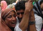 Kashmiri Muslim relatives of ruling party National Conference Block President Abdul Rehman Ganaie mourn during his funeral in Srinagar on June 15,2012. Suspected Muslim rebels gunned down Ganaie in the latest string of alleged political killings in Kashmir. Ganaie was shot at close range by suspected rebels as he was leaving his home to offer Friday prayers at a local mosque,police said