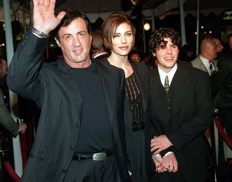 FILE - In this Dec. 5, 1996 file photo, Sylvester Stallone, left, star of the film "Daylight," arrives at the film's world premiere with his girlfriend Jennifer Flavin, center, and his son Sage Stallone, who co-stars in the film, in Hollywood district of Los Angeles.