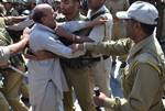 Jammu and Kashmir state lawmaker Engineer Abdul Rasheed scuffles with Indian policeman during a protest outside the state legislature house in Srinagar on September 29, 2011. Rasheed, was protesting against the stalling of a clemency request he moved in the house on September 28 for Afzal Guru, a man sentenced to death in a deadly 2001 attack on India's Parliament.