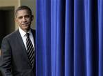 President Barack Obama pauses at the stage curtain as he arrives to sign the Claims Resolution Act of 2010 which settles long-standing lawsuits by African American farmers and Native Americans against the federal government, in the Eisenhower Executive Office Building, part of the White House complex, in Washington, Wednesday, Dec. 8, 2010. The act also authorizes $1.15 billion for black farmers who say they were discriminated against by the U.S. Department of Agriculture.