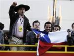 Rescued miners from the San Jose mine in Chile chant from the top of tour bus on Hollywood Boulevard across the street from a ceremony where Cher put her hands and feet in cement in front of Grauman's Chinese Theatre in Los Angeles, Thursday, Nov. 18, 2010.