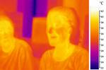 An image of two people in mid-infrared (