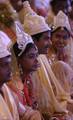 Brides and grooms sit during a mass marriage ceremony on 123 Couples who will be tying the knot out on 1st July 2012 at Haldiram Banquets organisational by Vishwa Jagriti Mission Trust in Kolkata on Sunday 1st July 2012