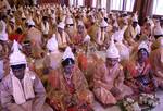 Brides and grooms sit during a mass marriage ceremony on 123 Couples who will be tying the knot out on 1st July 2012 at Haldiram Banquets organisational by Vishwa Jagriti Mission Trust in Kolkata on Sunday 1st July 2012