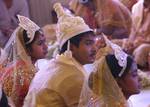 Brides and grooms sit during a mass marriage ceremony on 123 Couples who will be tying the knot out on 1st July 2012 at Haldiram Banquets organisational by Vishwa Jagriti Mission Trust in Kolkata on Sunday 1st July 2012