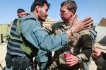 Capt. Joseph Driskell, an infantry company commander with the 82nd Airborne Division’s 1st Brigade Combat Team, hugs an Afghan policemen following a partnered operation to find a suspected weapons cache April 8, 2012, in southern Ghazni province, Afghanistan. Trusting each other on dangerous operations quickly breeds camaraderie. (U.S. Army photo by Sgt. Michael J. MacLeod)