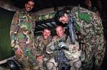 Spc. Jason Schmid, a paratrooper with the 82nd Airborne Division’s 1st Brigade Combat Team, shares photos with soldiers of the Afghan National Army at their post along Afghanistan’s Highway 1, April 20, 2012, in southern Ghazni province. Schmid is an infantryman with the 2nd Battalion, 504th Parachute Infantry Regiment. (U.S. Army photo by Sgt. Michael J. MacLeod)